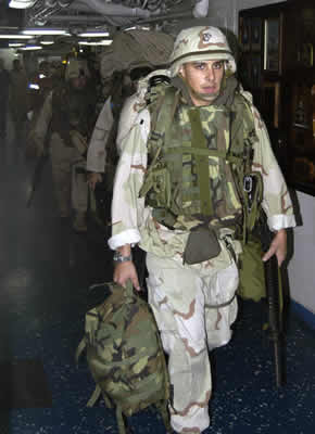 Marines walking out to the flight deck to catch their flight to Kuwait