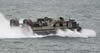 LCAC hovercraft heads towards the beach to drop off marine equipement