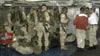 Marines receive instructions prior to boarding Helos